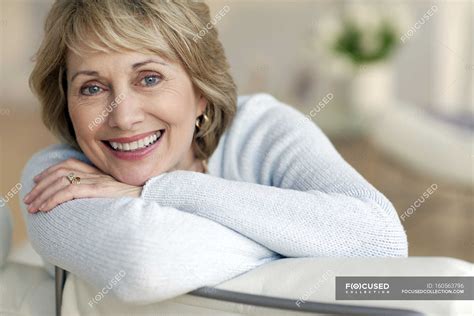 Attractive mature woman smiling — looking, Head In Hands - Stock Photo | #160563796