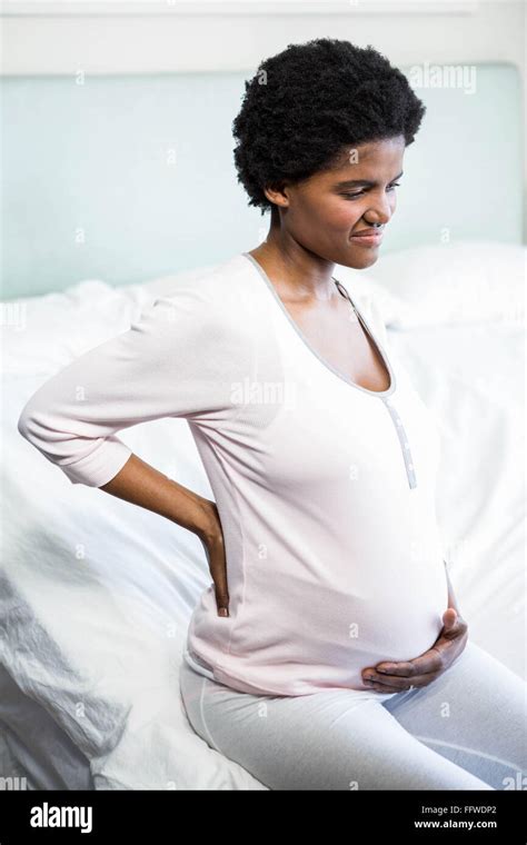 Pregnant woman with back pain Stock Photo - Alamy