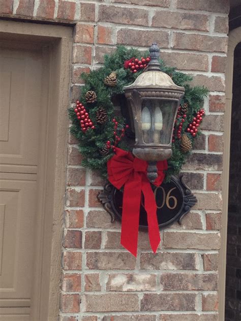 Made matching wreaths for the lights on the garage. I used pine cones from the back yard ...