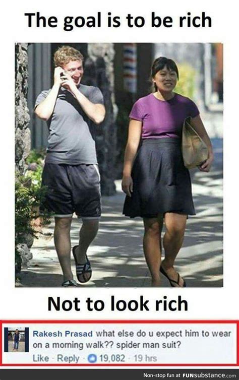 a man and woman walking down the street talking on their cell phones, texting not to look rich