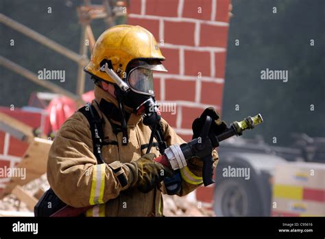 UK Firefighter with a CAFS hose Stock Photo - Alamy