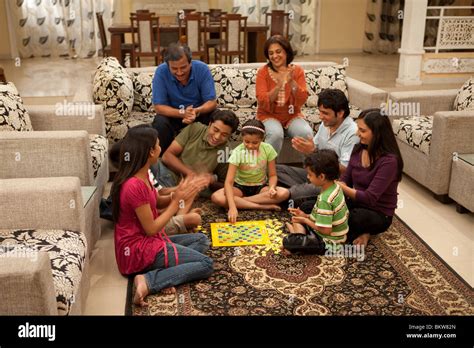 Three generation family playing scrabble in the living room Stock Photo - Alamy