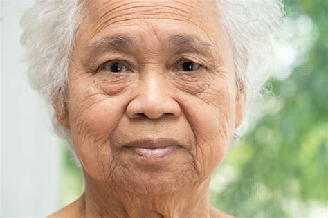 Premium Photo | Asian elderly old woman face and eye with wrinkles portrait closeup view