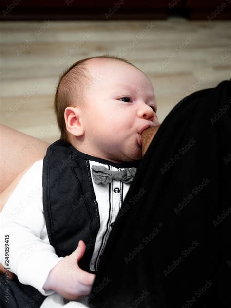 Close up of mother breast feeding her newborn baby boy at home, Happy baby Cute 4 months old ...