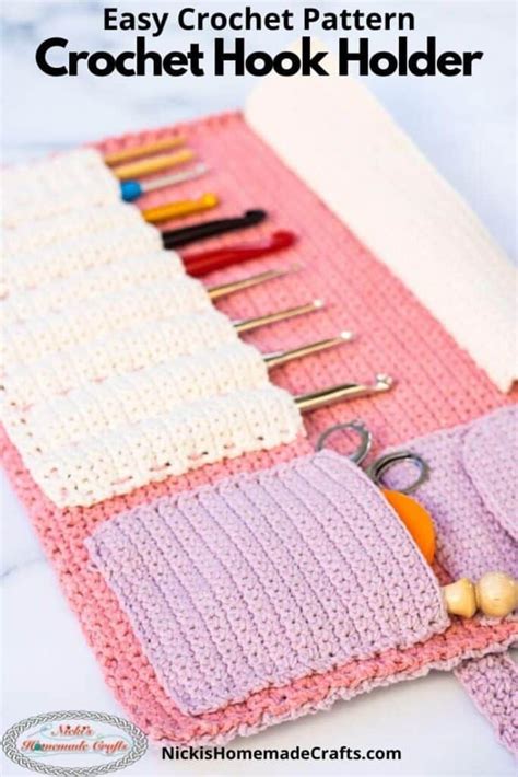 a pink and white crochet purse with scissors, needles, yarns and other crafting supplies