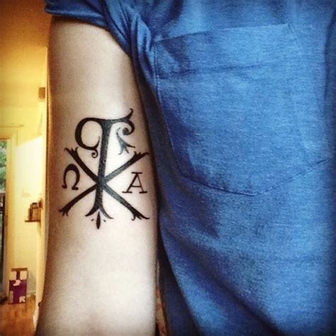 Christ monogram Chi Rho special symbol dark black ink tattoo on biceps - Tattooimages.biz