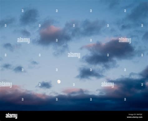 Moon and evening sky with clouds Stock Photo - Alamy