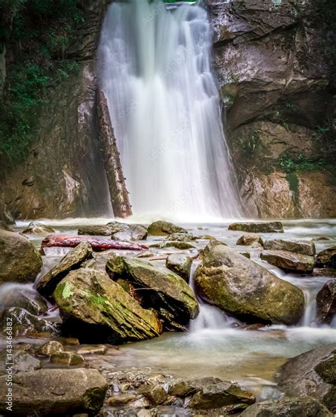 nature scenery, landscape with waterfall, cascade on long exposure, flowing water among rocks ...