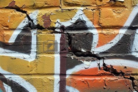 Royalty Free Image | Bright graffiti on a cracked brick wall by anikasalsera