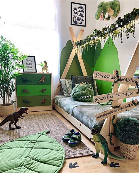 an image of a bedroom with dinosaur toys on the floor and in front of it