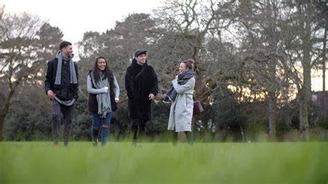 Group Of Young Friends Walking Through Park In Winter 1282317 Stock Video at Vecteezy