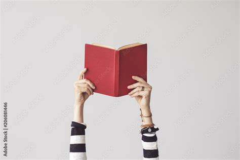 The hand holding book on isolated background Stock Photo | Adobe Stock