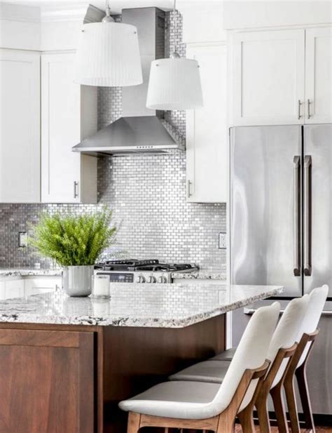 small scale silver tiles in a white kitchen for a bold and shiny touch