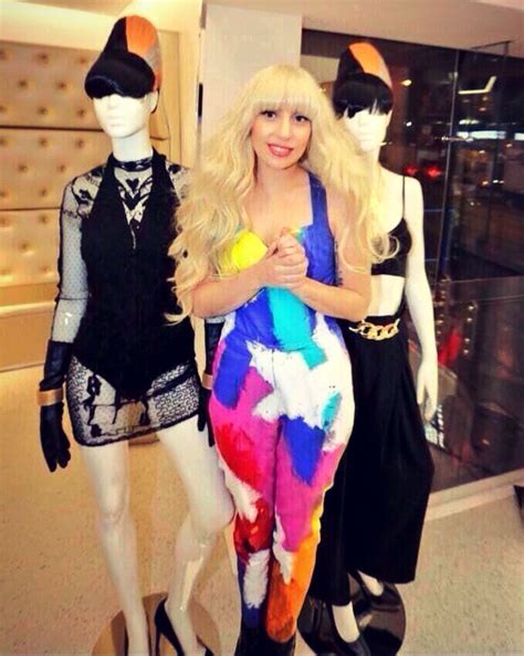 Lady Gaga in H&M wearing an ARTPOP Era outfit in front of two Born This Way Era mannequins. Star ...