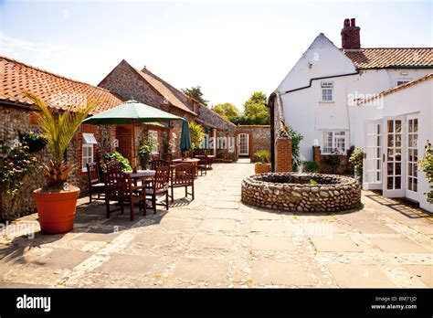 Courtyard and fishpond at Blakeney Manor Hotel, Blakeney, Norfolk Stock Photo - Alamy