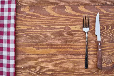 HD wallpaper: stainless steel fork and knife on brown wooden surface, table | Wallpaper Flare