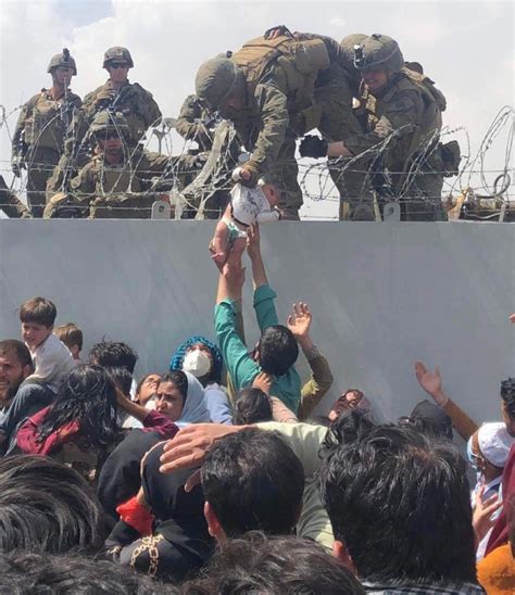 Baby passed over wall in Afghanistan reunited with parent after stunning scene at Kabul airport