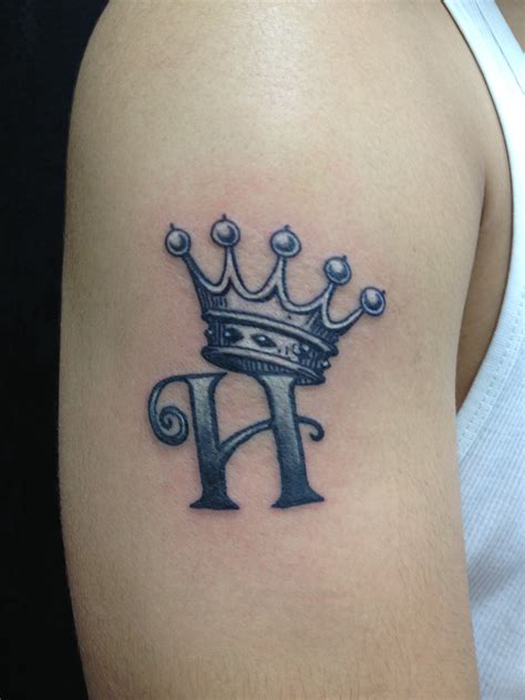 H Letter And Crown Tattoo On Right Shoulder