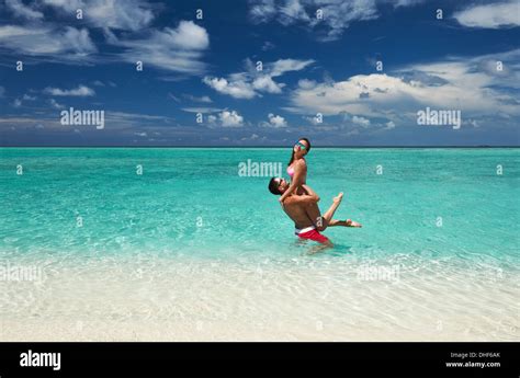 Couple on a beach at Maldives Stock Photo - Alamy