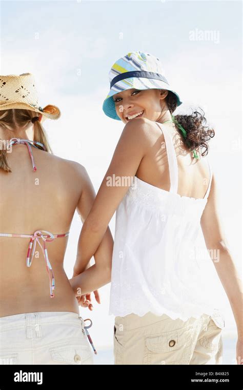 Friends walking on beach Stock Photo - Alamy