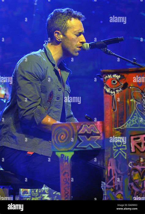 Singer Chris Martin of the band Coldplay plays piano during a concert at the 'E-Werk' in Cologne ...