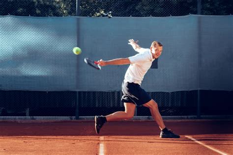 Premium Photo | Proffesional tennis player beats off a ball during match