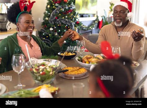 Happy african american family praying before having christmas meal Stock Photo - Alamy