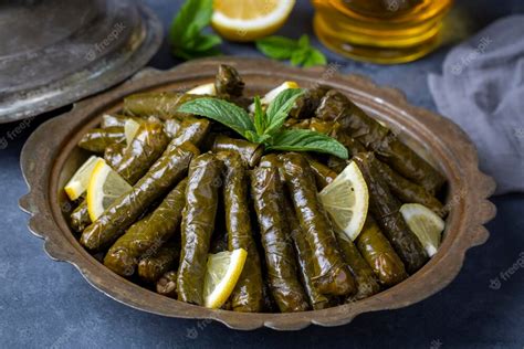 Premium Photo | Delicious dolma (sarma) stuffed grape leaves rice, white yogurt sauce. lebanese ...