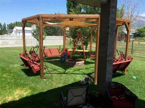 DIY round pergola with swings, firepit and shade screen featured on @Remodelaholic | Fire pit ...