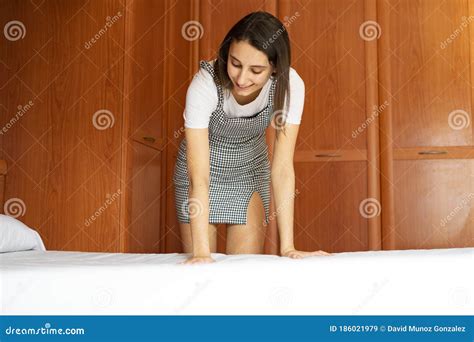 Cleaning Worker Making Bed in a Hotel Room. Concept of a Hotel Cleaning Service Stock Image ...