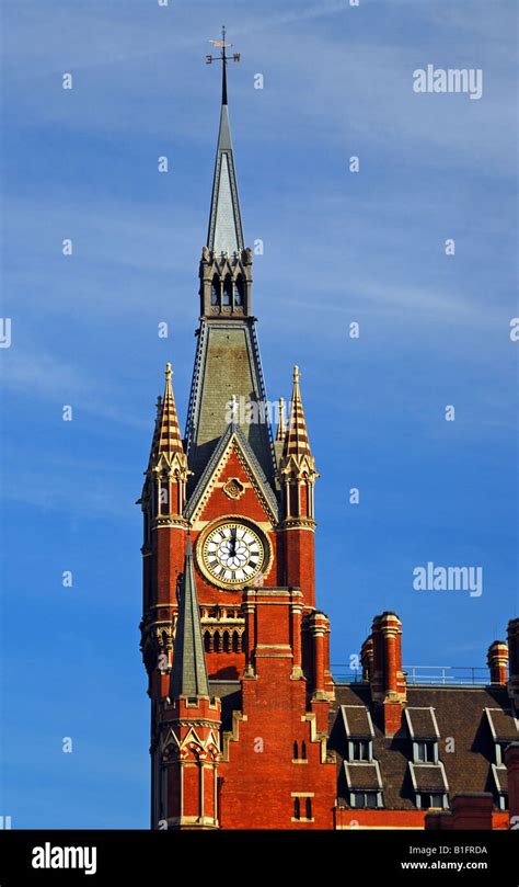 St Pancras station clock tower with blue sky background Stock Photo - Alamy