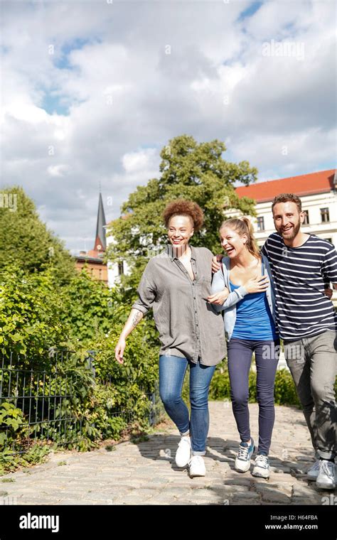 Happy friends walking in park Stock Photo - Alamy