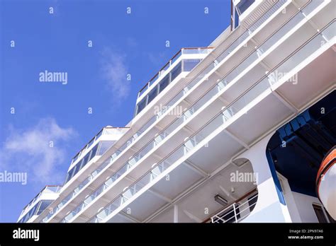 A close up on a large cruise ship in the sunshine showing the cruise ships balconies on a hot ...