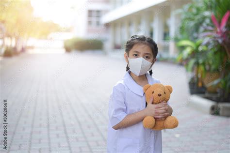 Asian student girl wearing protective face mask Protect from the corona virus or Coronavirus ...