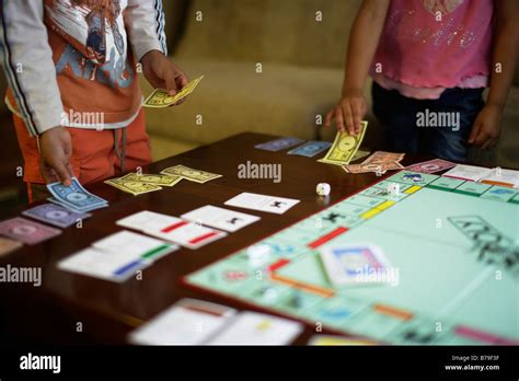 Children playing monopoly UK version Stock Photo - Alamy