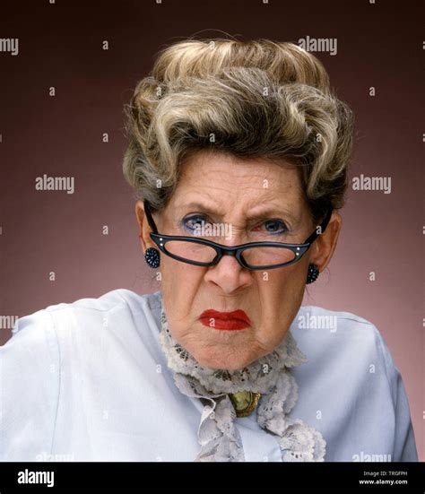 Grumpy old lady wearing glasses Stock Photo - Alamy