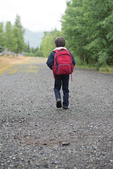 "Young Boy Walks The Path To School Wearing A Backpack" by Stocksy Contributor "Tara Romasanta ...