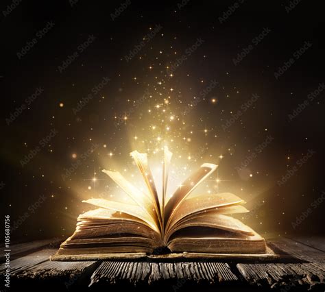 Old Book With Magic Lights On Vintage Table Stock Photo | Adobe Stock