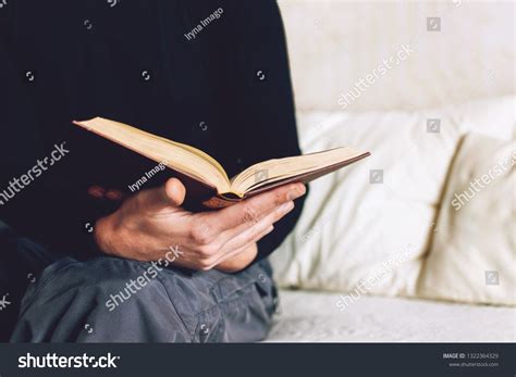 Man holding Open book in hands. Male hands hold a hardcover book. Education, literature ...