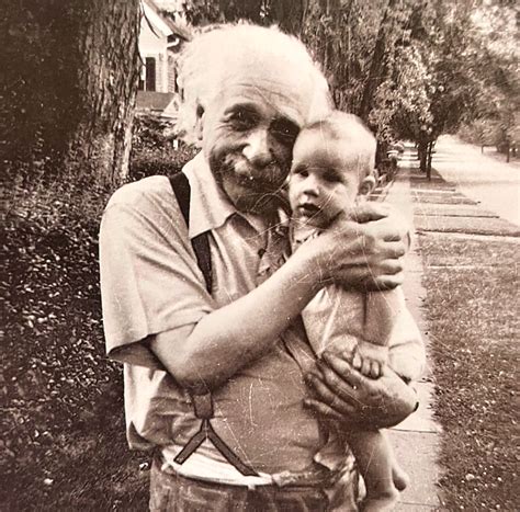 Albert Einstein holding his neighbor’s son. I thought it belonged on this sub. : r/aww