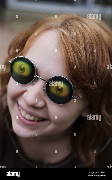 A girl wearing glasses with big weird eyeballs Stock Photo - Alamy