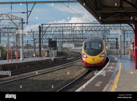 Virgin train arriving in Stockport railway station Stock Photo - Alamy