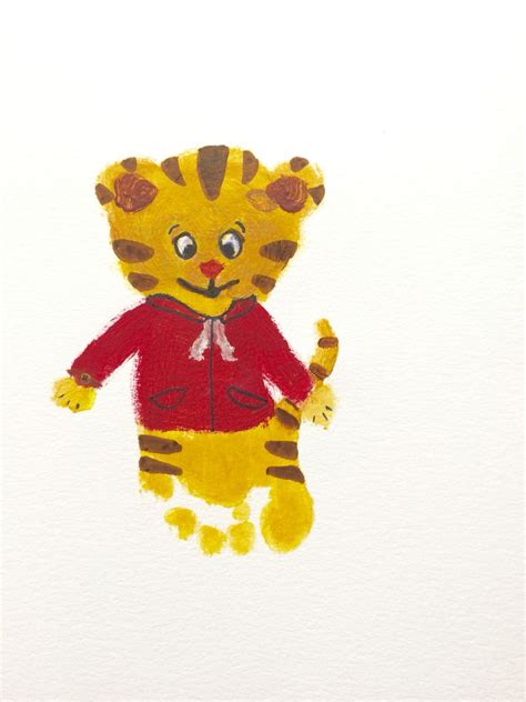 A first attempt at Daniel tiger footprint art #footprintart #toddlerart #danieltiger Footprint ...