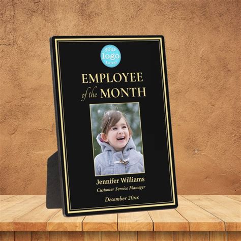 an employee of the month plaque on a wooden table