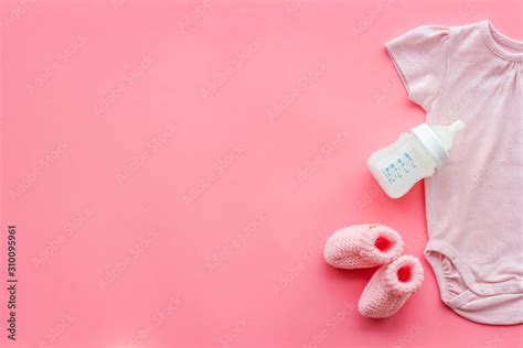 Baby background - pink color. Clothes, booties and accessories for newborn girl on pink table ...