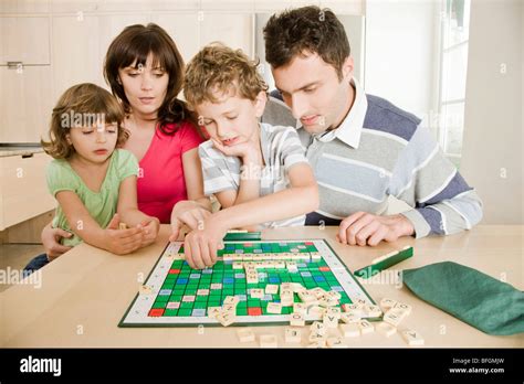 family playing scrabble Stock Photo - Alamy