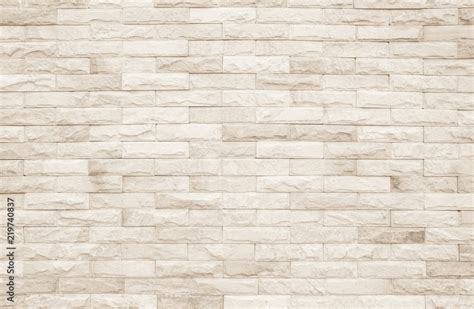 Cream and white brick wall texture background. Brickwork or stonework flooring interior rock old ...