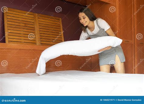 Cleaning Worker Making Bed in a Hotel Room. Concept of a Hotel Cleaning Service Stock Image ...