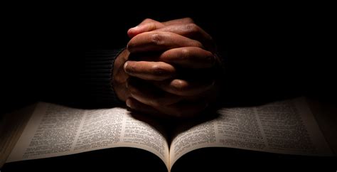 African American Man Praying with Hands on Top of the Bible. - Break Point