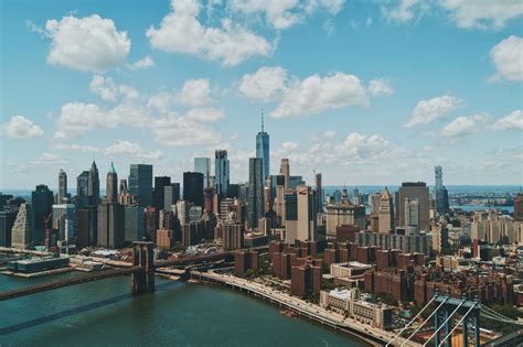 the new york city skyline and manhattan bridge at sunset, manhattan in the distance 4k HD Wallpaper